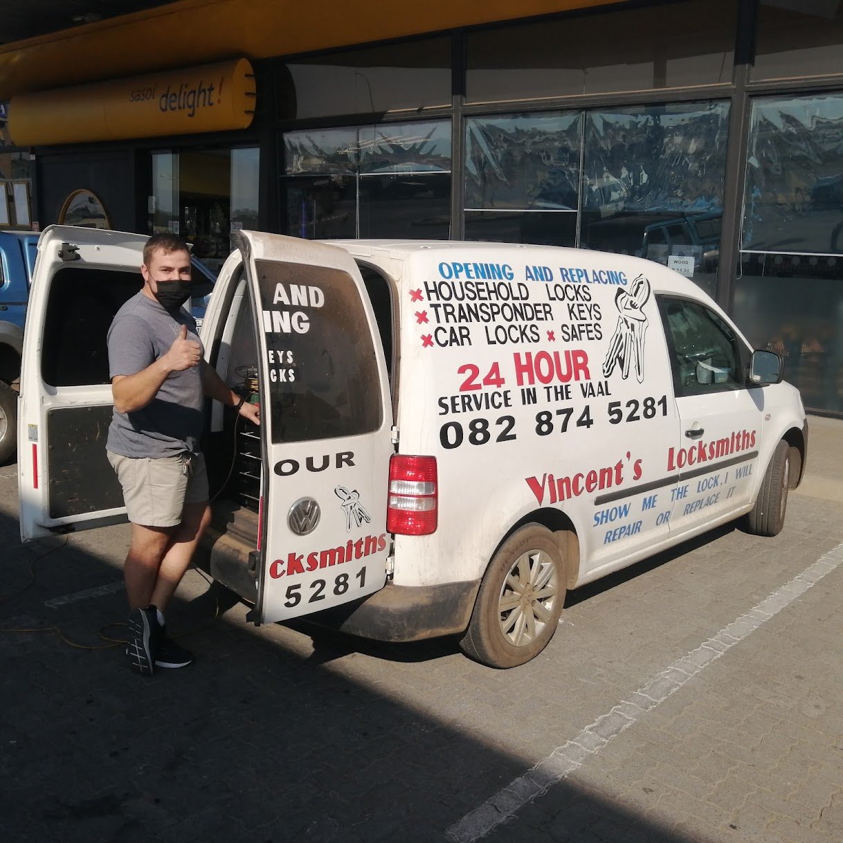 Vincent’s branded service van with a technician beside the open rear door